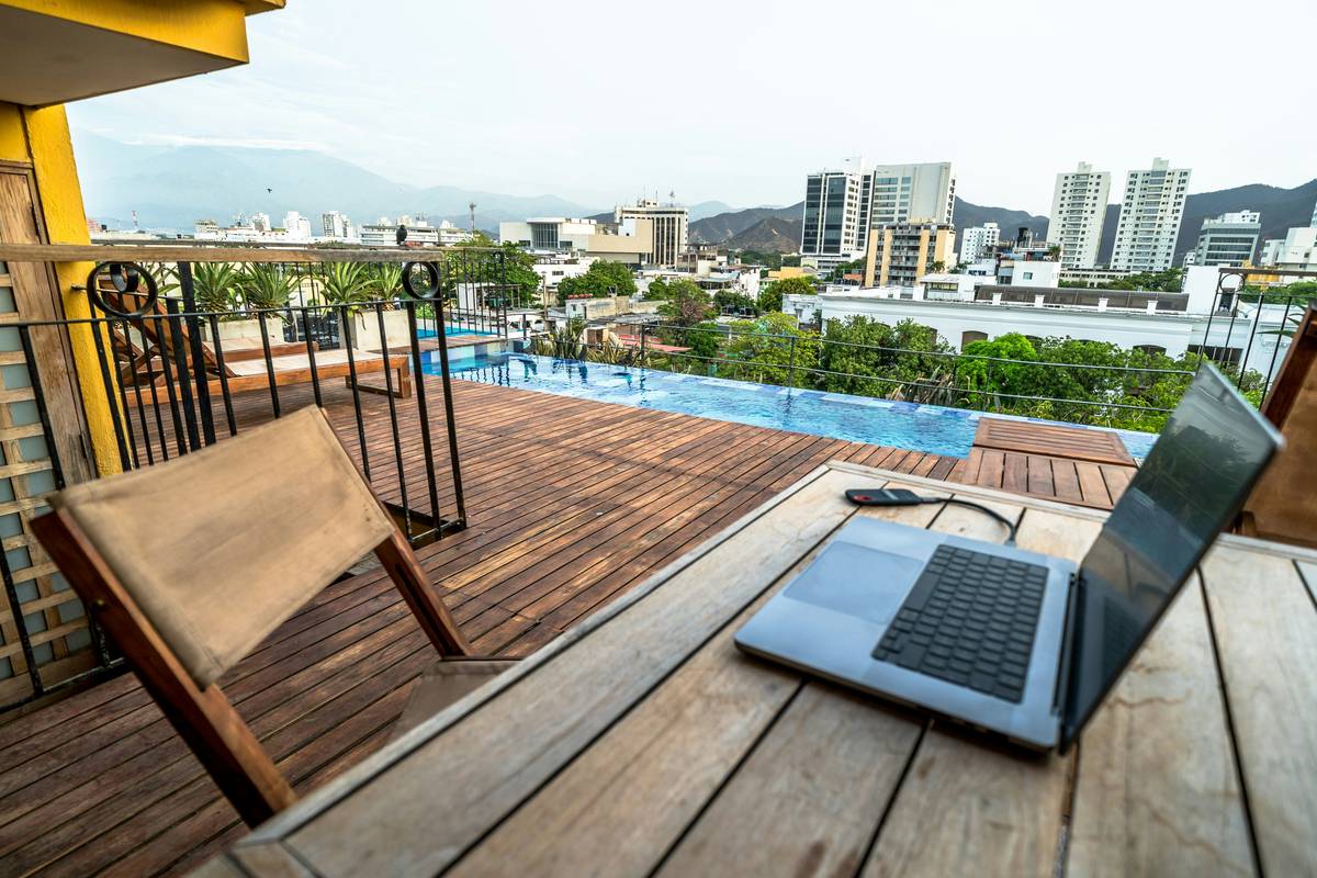 Digital nomad troubleshooting laptop on a mountain trail with the phrase how to keep from losing remote visible on screen
